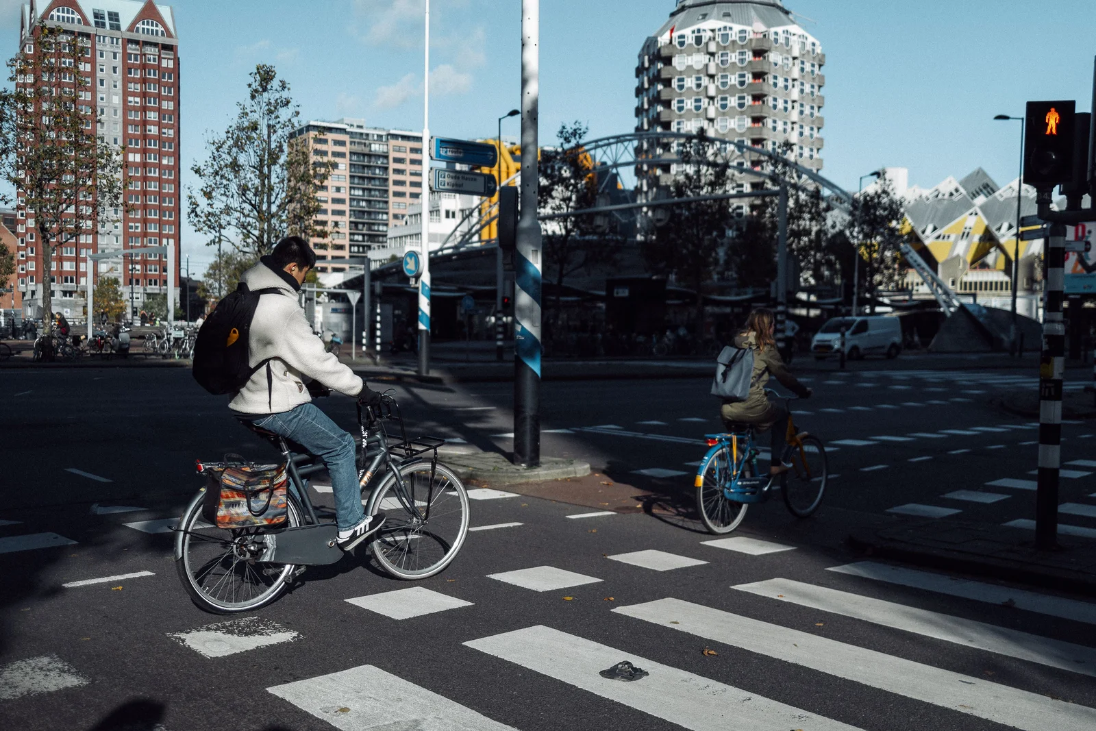 Cyclists crossing a street in Rotterdam near the Cube Houses